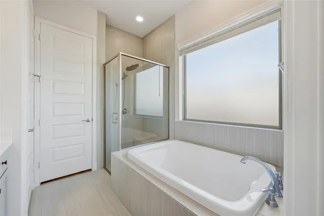 a bathroom with a white bath tub and shower