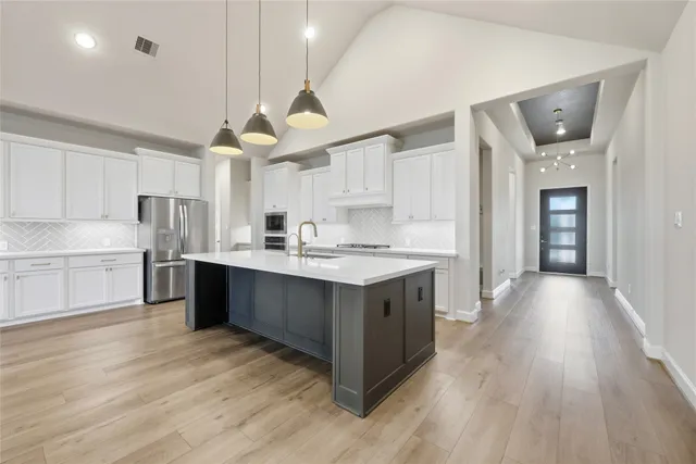a kitchen with stainless steel appliances granite countertop a sink counter space and cabinets