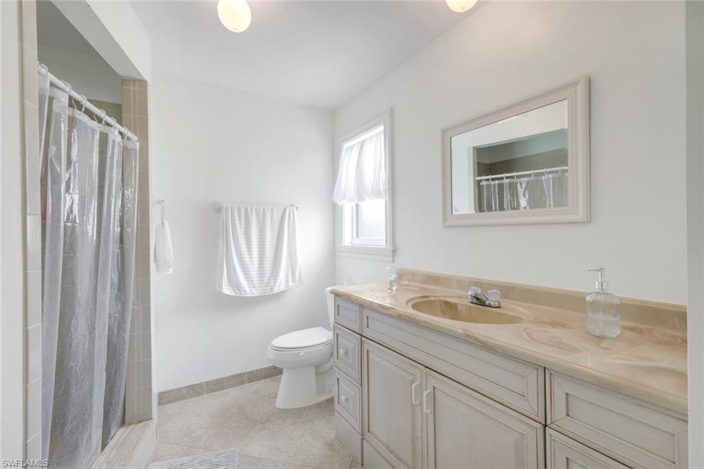 59 Hilo Court, Unit 59 Naples, FL 34112 - Photo 15 of 25 a bathroom with a granite countertop sink and a mirror