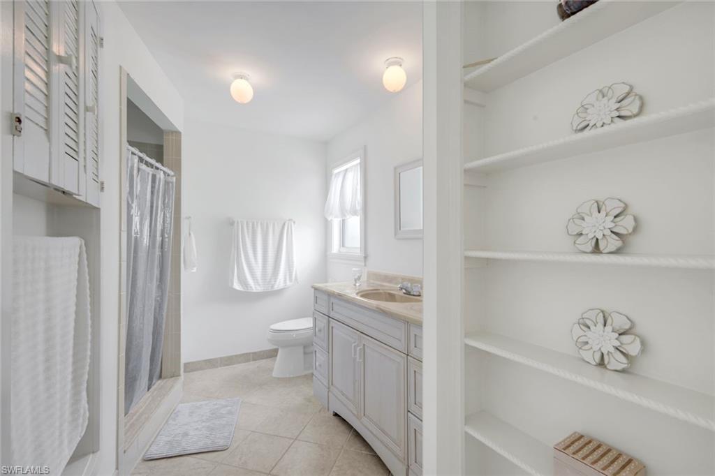 59 Hilo Court, Unit 59 Naples, FL 34112 - Photo 16 of 25 a bathroom with a sink a toilet and a shower