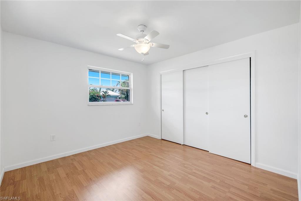 59 Hilo Court, Unit 59 Naples, FL 34112 - Photo 17 of 25 a view of an empty room with wooden floor