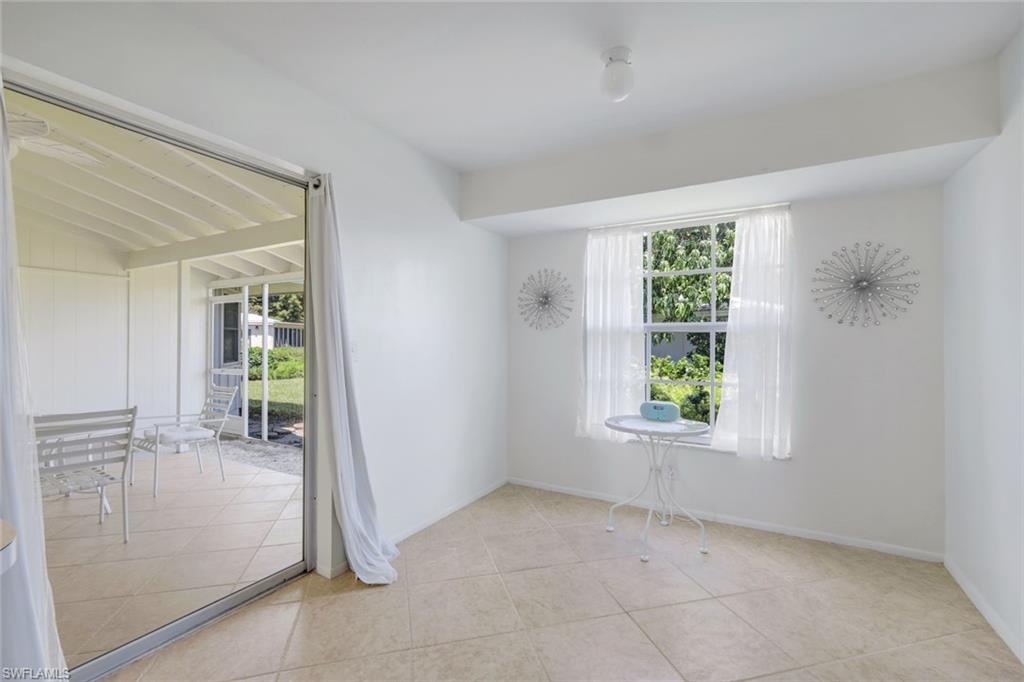 59 Hilo Court, Unit 59 Naples, FL 34112 - Photo 19 of 25 an empty room with windows and entrance