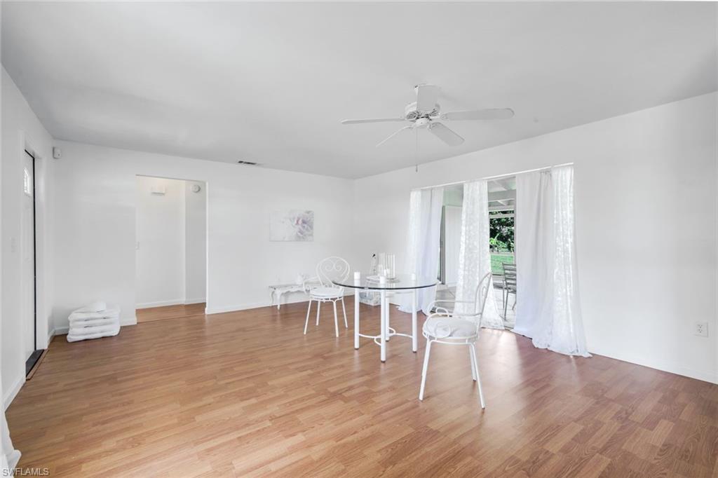 59 Hilo Court, Unit 59 Naples, FL 34112 - Photo 5 of 25 a view of a dining room with furniture window and wooden floor