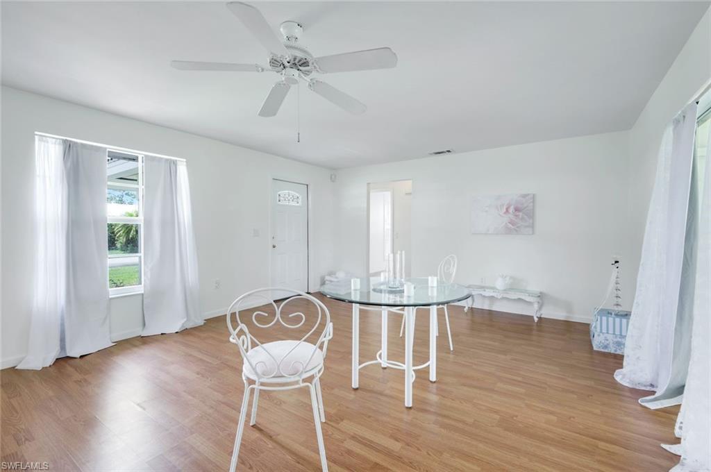 59 Hilo Court, Unit 59 Naples, FL 34112 - Photo 7 of 25 a view of table and chair in room with wooden floor