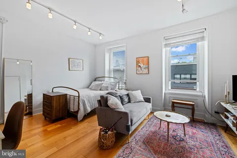 a living room with furniture rug and a window