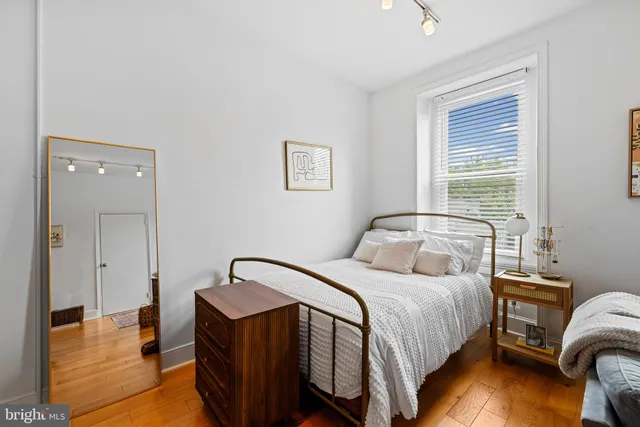 a bedroom with a bed and a night stand