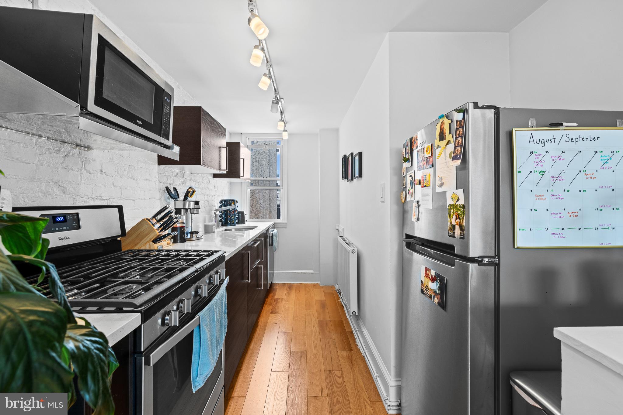726 South 19th Street Philadelphia, PA 19146 - Photo 8 of 12 a kitchen with stainless steel appliances granite countertop a stove and a refrigerator