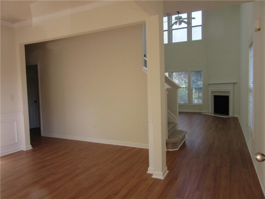 3357 Wyesham Circle Duluth, GA 30096 - Photo 3 of 26 wooden floor in an empty room with a fireplace