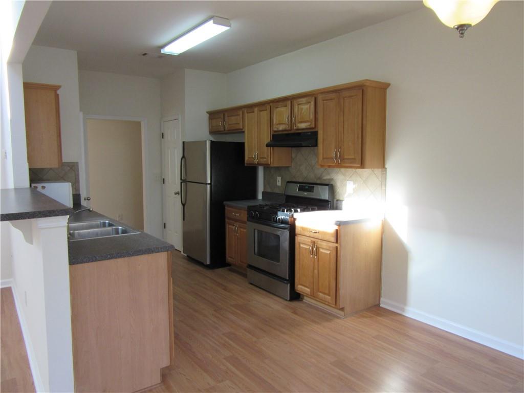 3357 Wyesham Circle Duluth, GA 30096 - Photo 10 of 26 a kitchen with a refrigerator stove and a sink