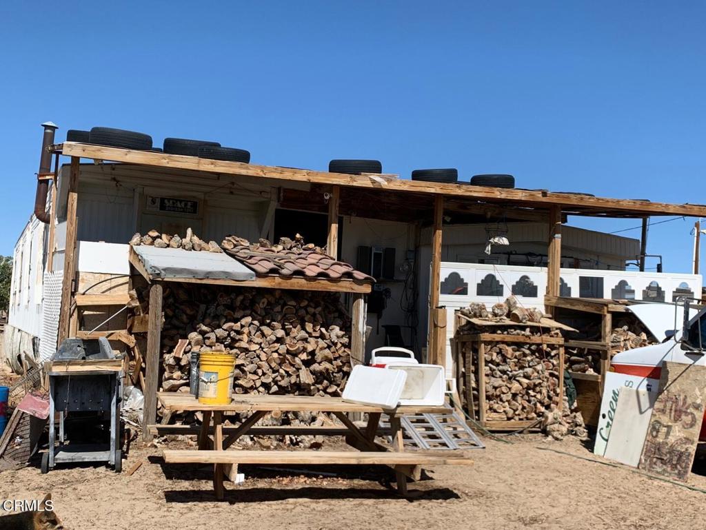 10080 Santa Fe Fire Road Lucerne Valley, CA 92356 - Photo 30 of 36 a view of a patio with table and chairs with an outdoor space