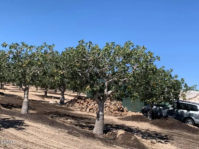 a view of a house with a wooden fence