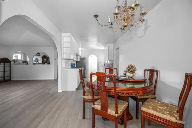 a view of a livingroom with wooden floor and furniture