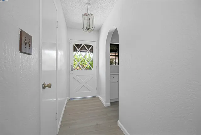 a kitchen with granite countertop lots of counter top space and wooden floor
