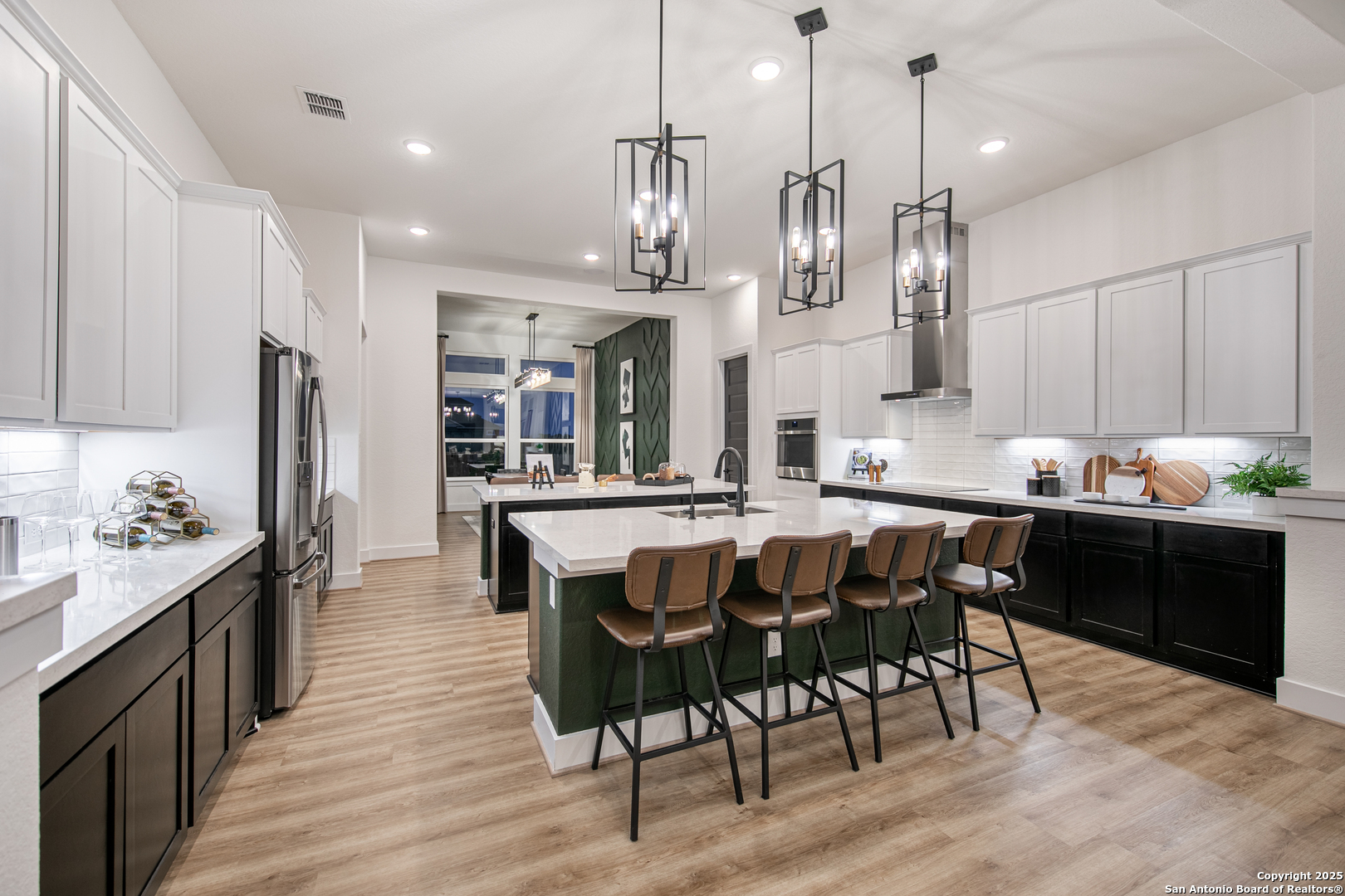 527 Corwin Springs Cibolo, TX 78108 - Photo 11 of 21 a kitchen with stainless steel appliances kitchen island granite countertop a table chairs sink and cabinets