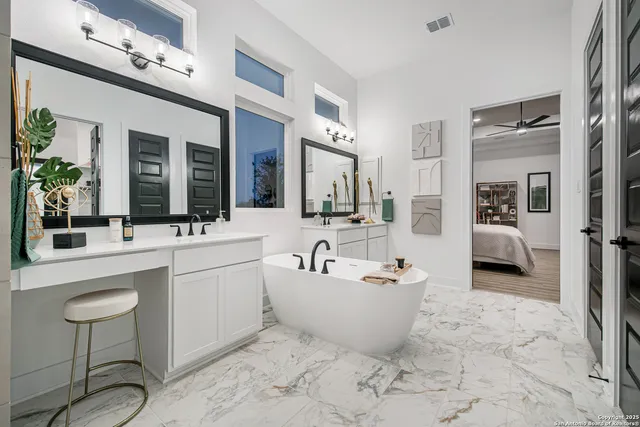 a bathroom with a tub sink and mirror