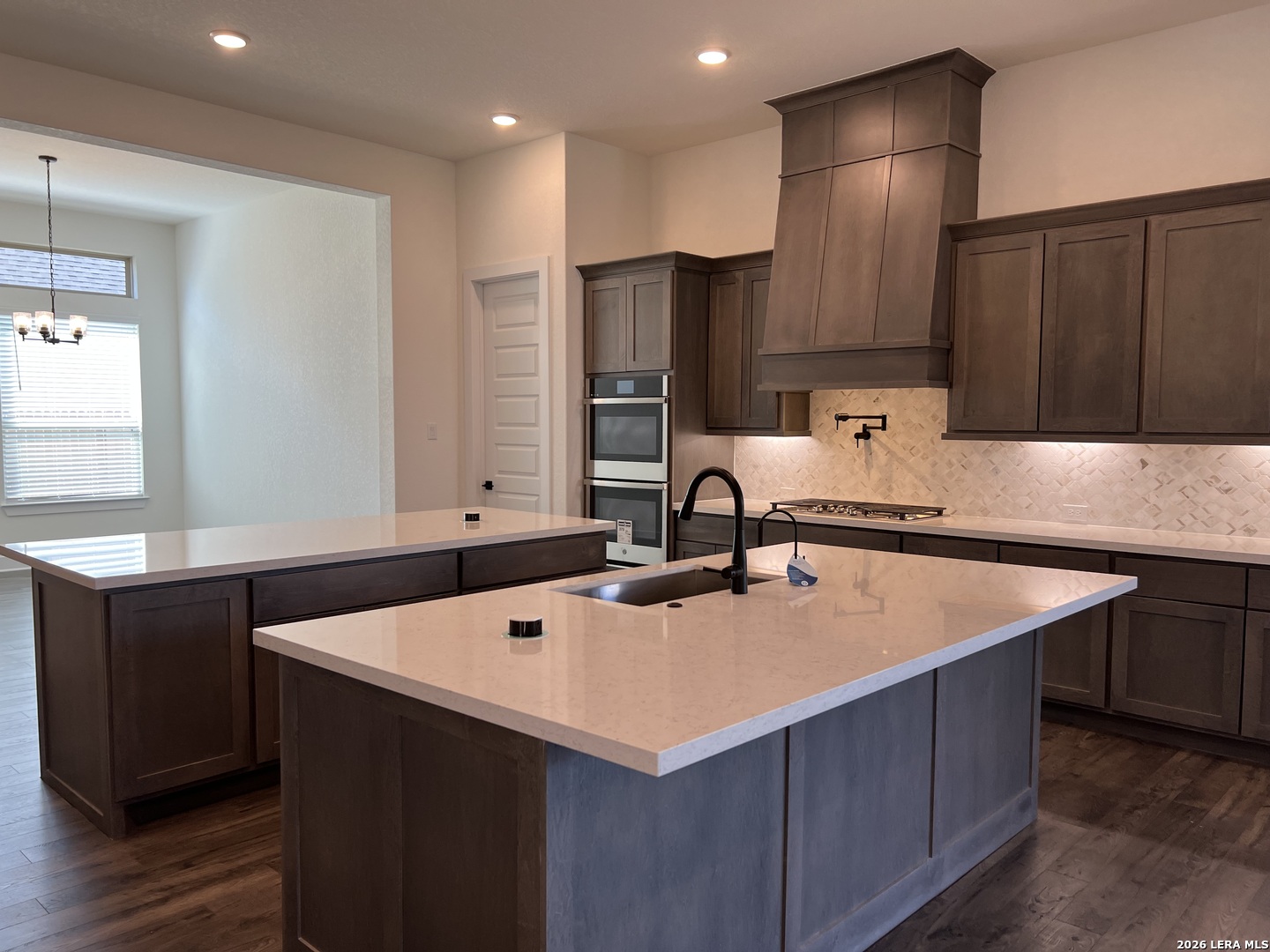 527 Corwin Springs Cibolo, TX 78108 - Photo 3 of 21 a kitchen with kitchen island granite countertop a sink and a refrigerator