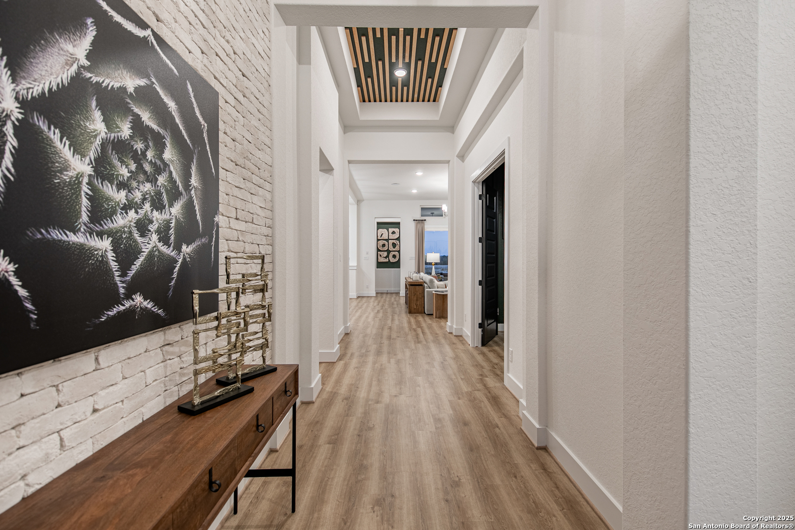 527 Corwin Springs Cibolo, TX 78108 - Photo 8 of 21 a view of a hallway with wooden floor and livingroom with wooden floor