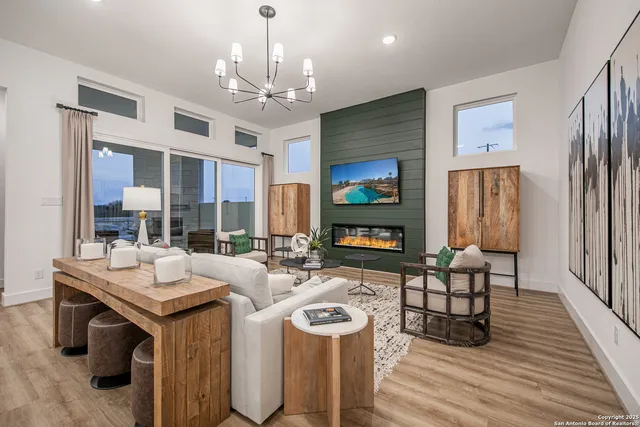 a view of a dining room with furniture a chandelier and wooden floor