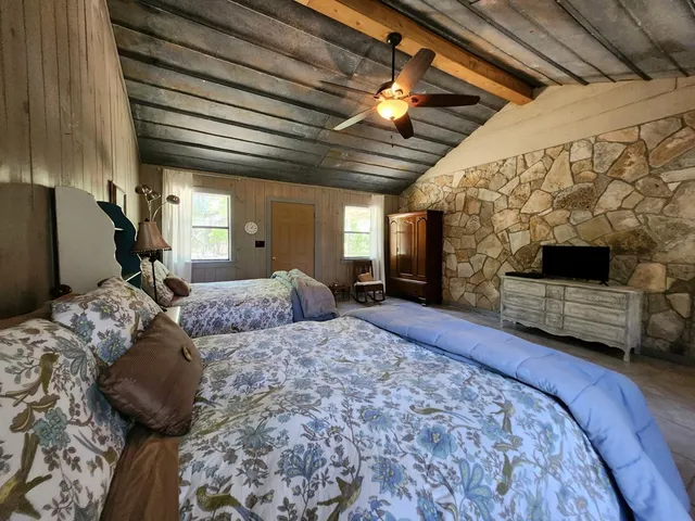 a bedroom with bed and a chandelier