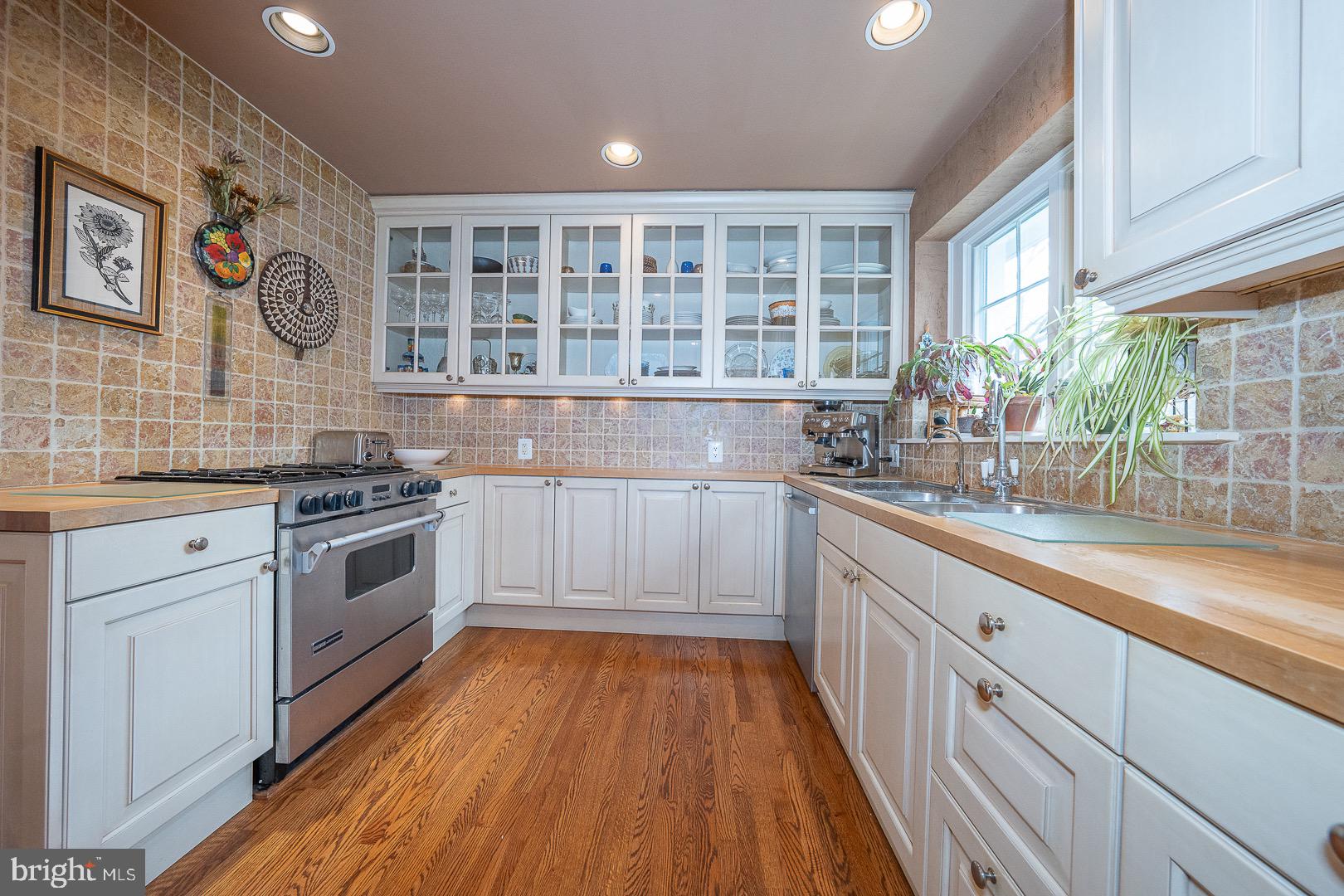 517 Howe Road Merion Station, PA 19066 - Photo 21 of 71 a kitchen with stainless steel appliances a stove a sink and a hard wood floor