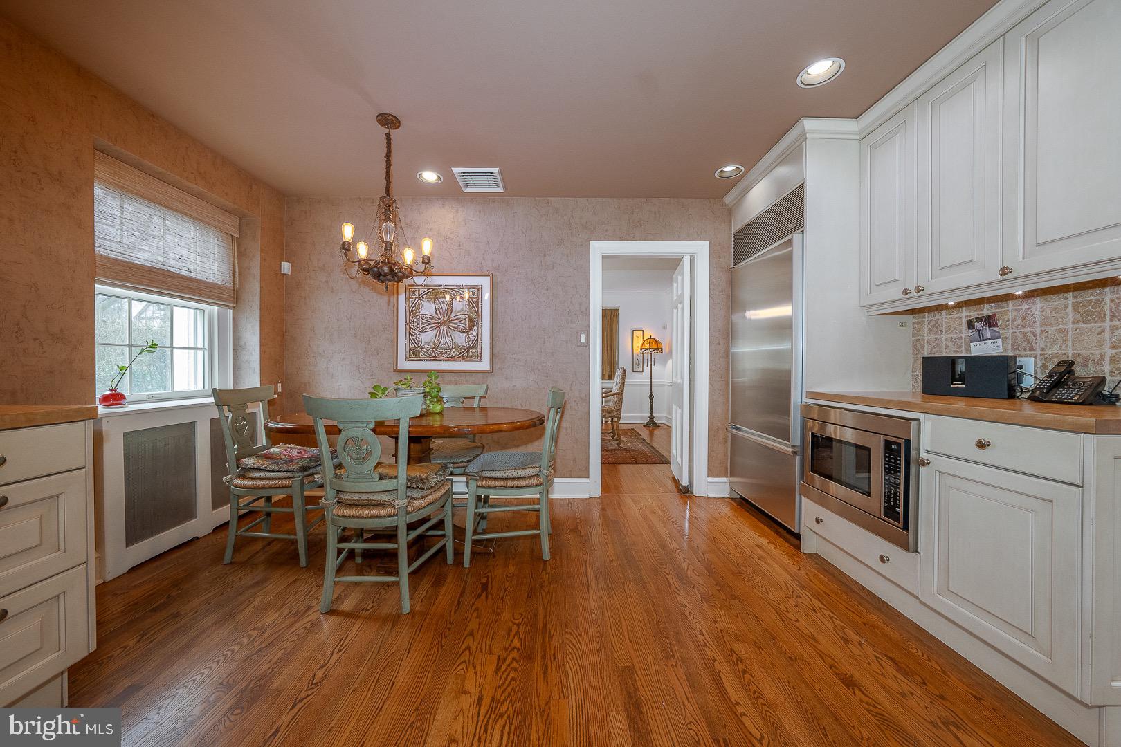 517 Howe Road Merion Station, PA 19066 - Photo 23 of 71 a kitchen with stainless steel appliances a dining table chairs and wooden floor