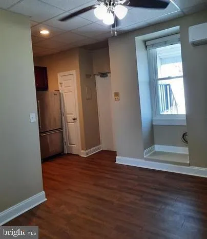 an empty room with wooden floor and a window