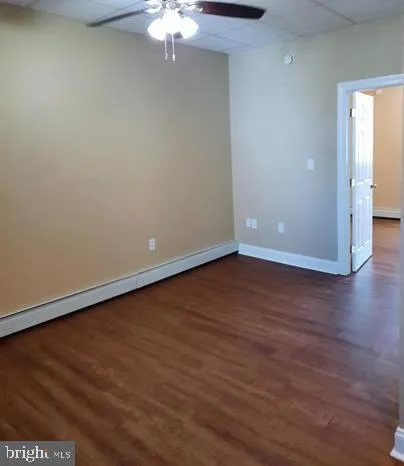 a view of an empty room with wooden floor