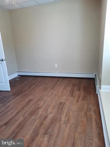 a view of room with wooden floor