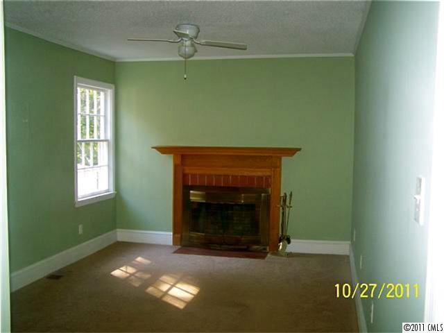 14024 Cabarrus Road Charlotte, NC 28227 - Photo 6 of 12 a living room with a fireplace and a window