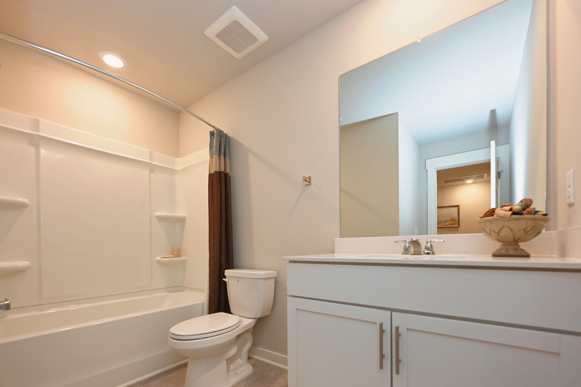 704 Mickelson Way Lebanon, TN 37087 - Photo 27 of 38 a bathroom with a double vanity sink toilet mirror and shower