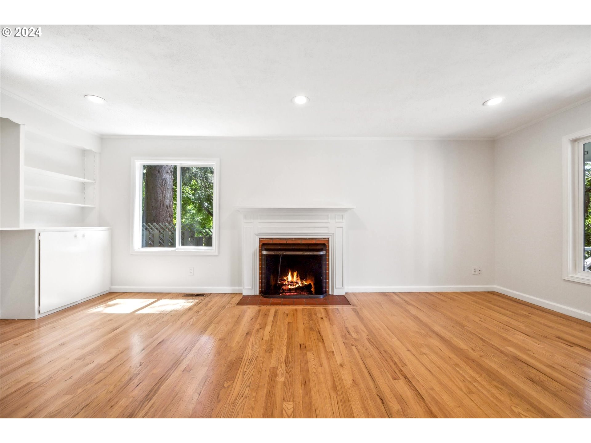10097 Southwest Walker Road Portland, OR 97225 - Photo 11 of 44 a view of an empty room with a fireplace and a window