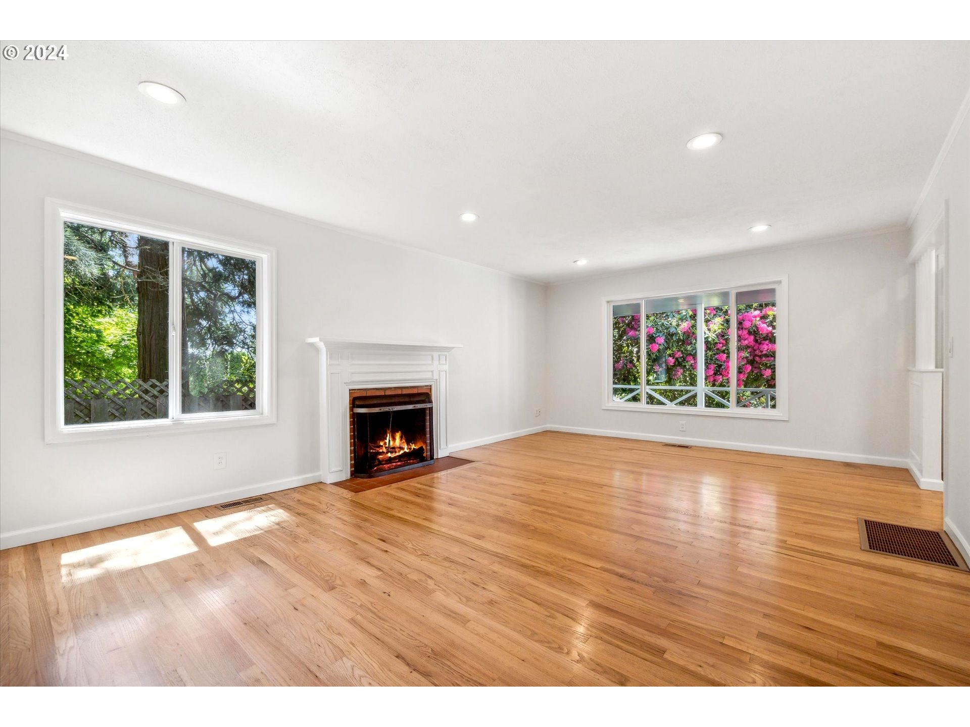 10097 Southwest Walker Road Portland, OR 97225 - Photo 12 of 44 a view of empty room with wooden floor and fireplace