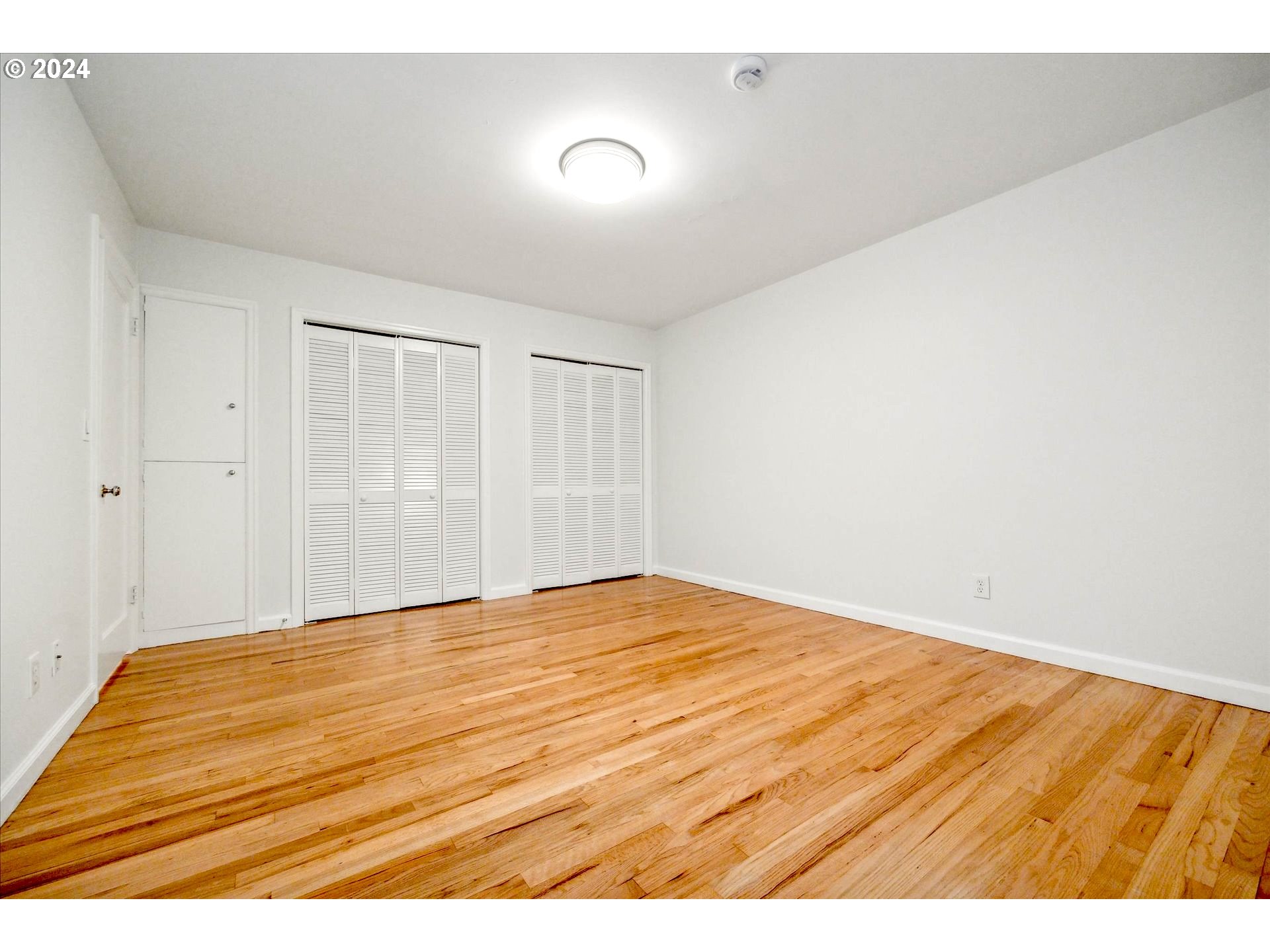 10097 Southwest Walker Road Portland, OR 97225 - Photo 15 of 44 a view of empty room with wooden floor