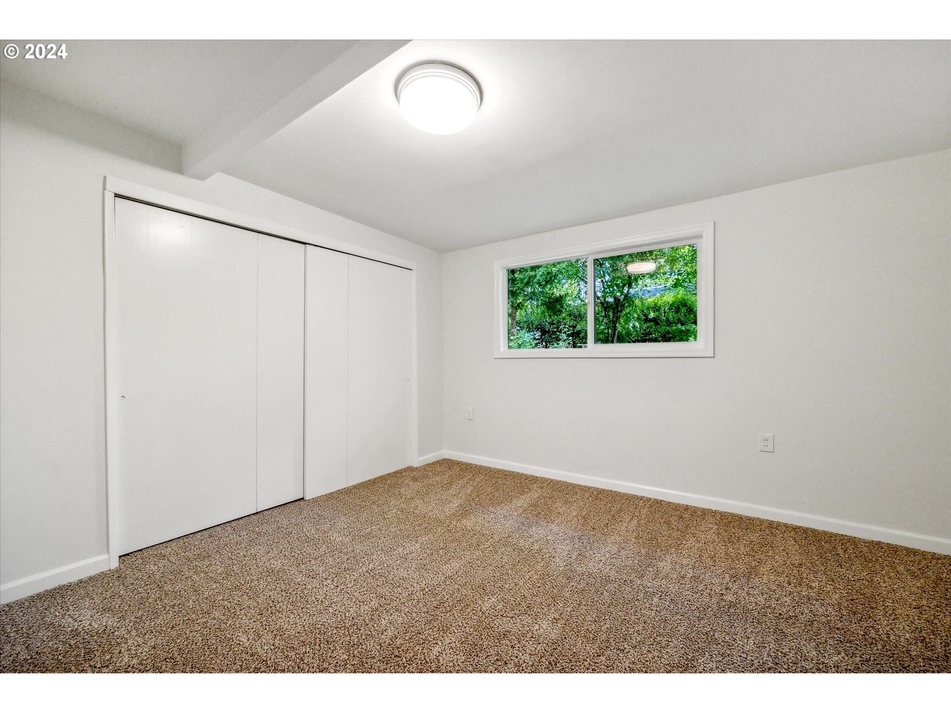 10097 Southwest Walker Road Portland, OR 97225 - Photo 20 of 44 a view of an empty room with a window