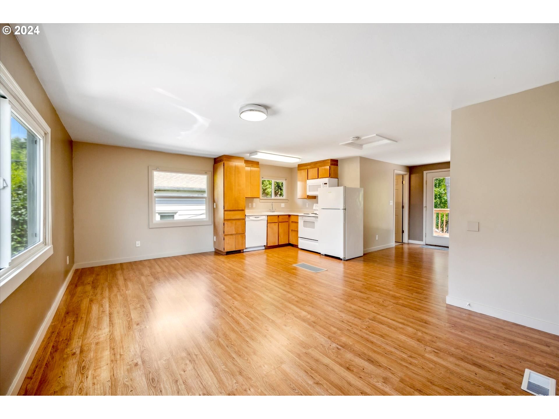 10097 Southwest Walker Road Portland, OR 97225 - Photo 23 of 44 an empty room with wooden floor and windows