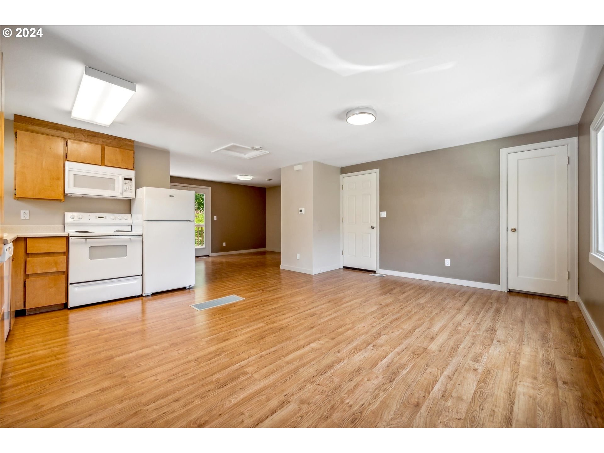 10097 Southwest Walker Road Portland, OR 97225 - Photo 25 of 44 a view of a kitchen with a sink a dishwasher and a refrigerator