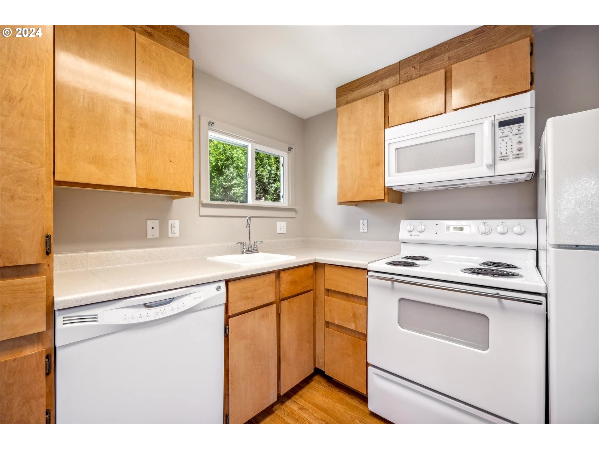 10097 Southwest Walker Road Portland, OR 97225 - Photo 26 of 44 a kitchen with a sink cabinets and window