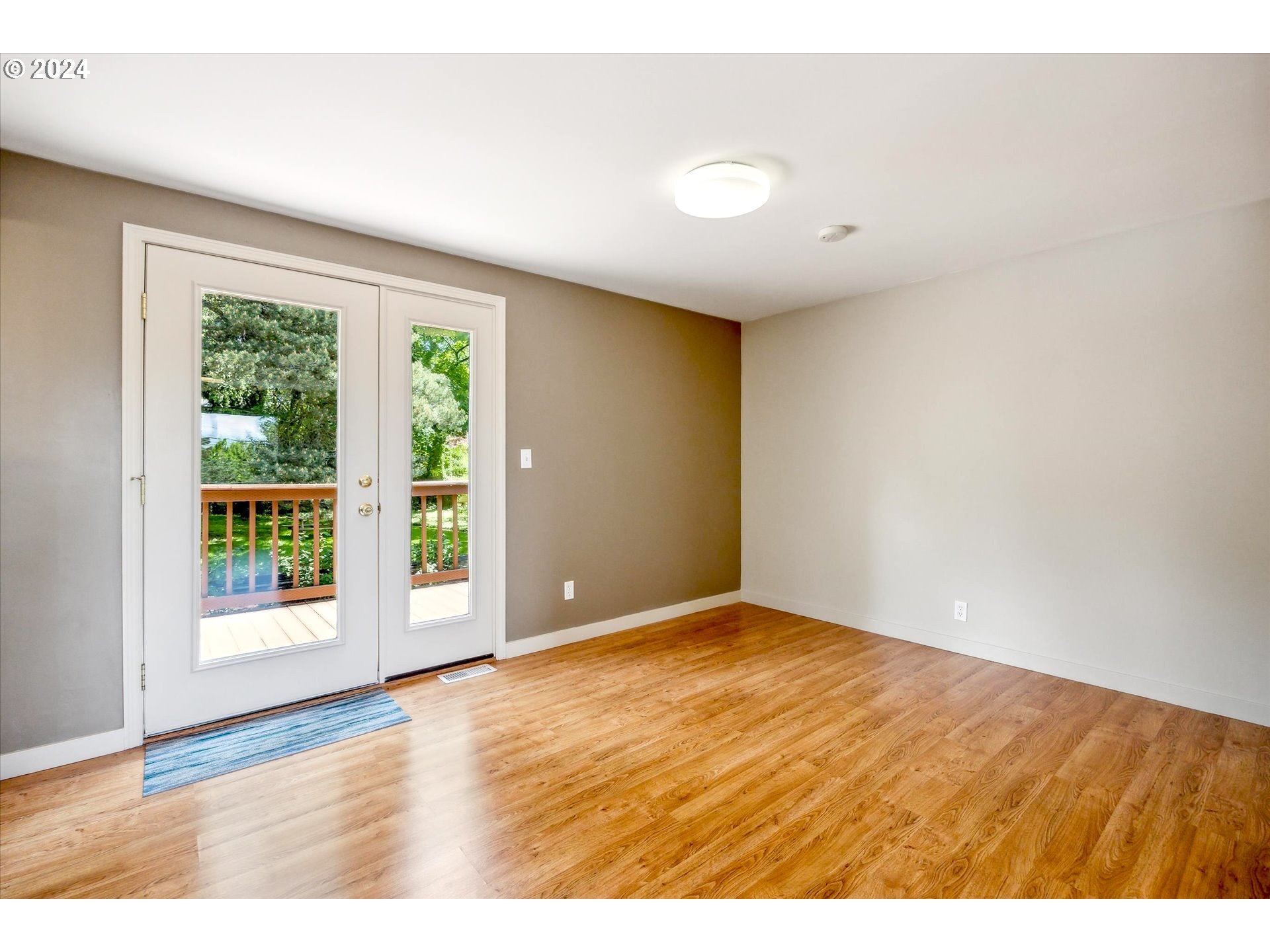 10097 Southwest Walker Road Portland, OR 97225 - Photo 28 of 44 a view of an empty room with wooden floor and a window