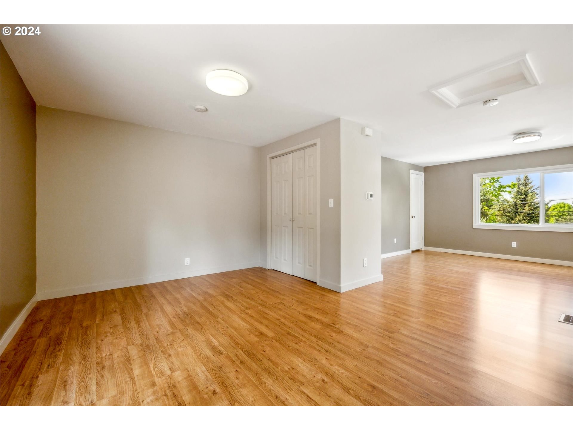 10097 Southwest Walker Road Portland, OR 97225 - Photo 29 of 44 a view of an empty room with window and wooden floor