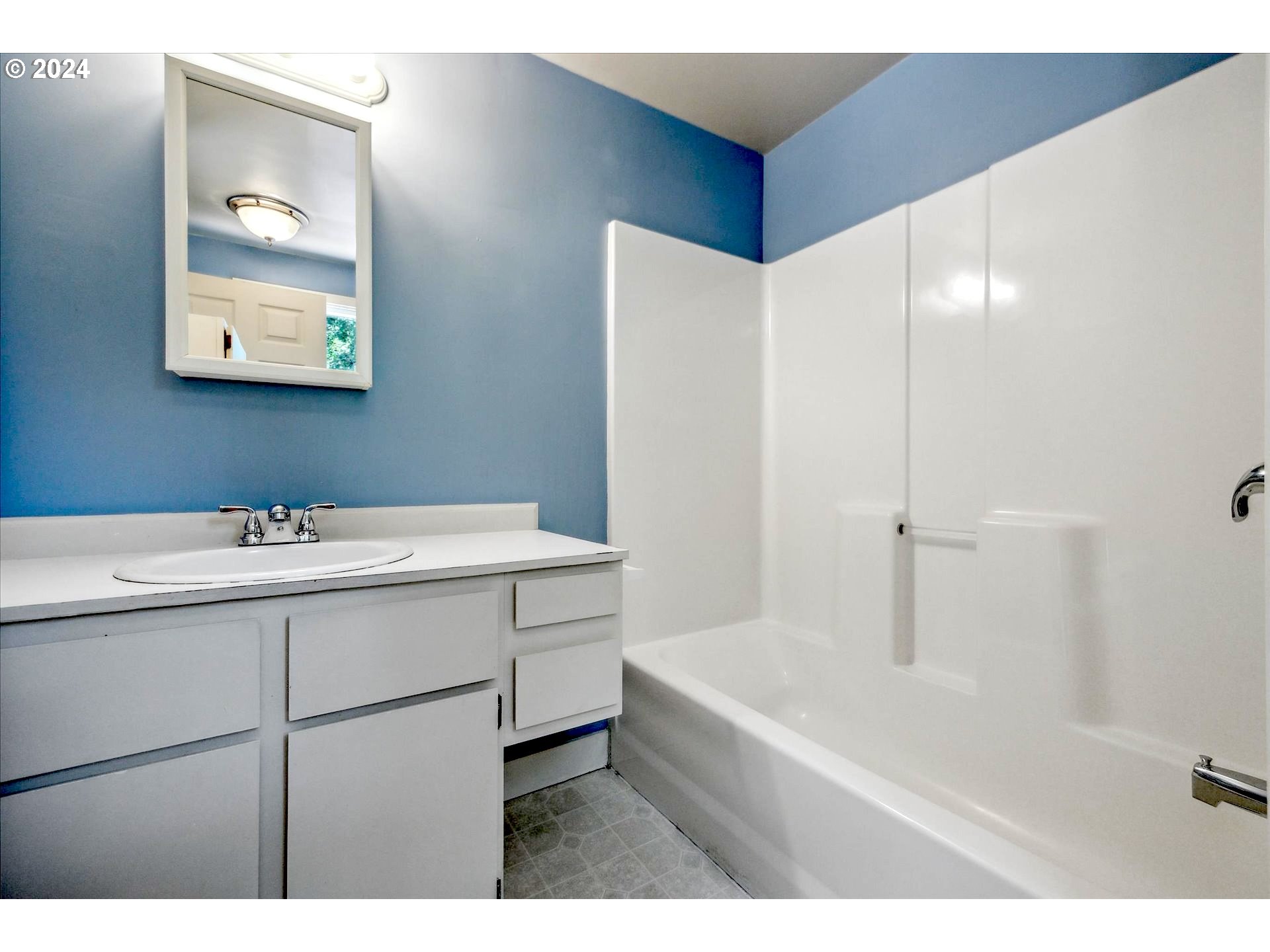 10097 Southwest Walker Road Portland, OR 97225 - Photo 31 of 44 a bathroom with a tub sink and mirror