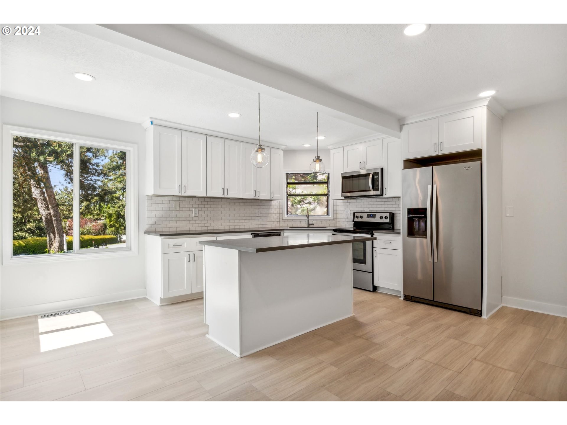 10097 Southwest Walker Road Portland, OR 97225 - Photo 4 of 44 a kitchen with stainless steel appliances a refrigerator sink and microwave
