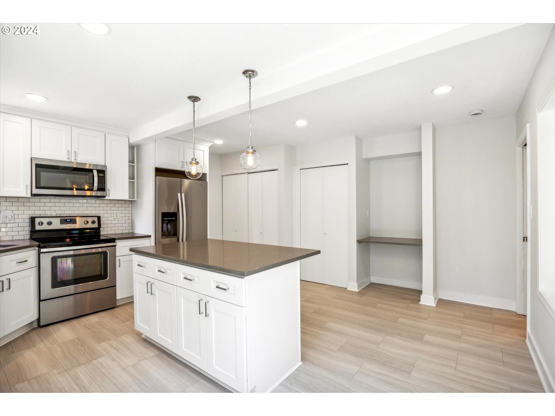 10097 Southwest Walker Road Portland, OR 97225 - Photo 7 of 44 a kitchen with a sink a microwave a stove and refrigerator