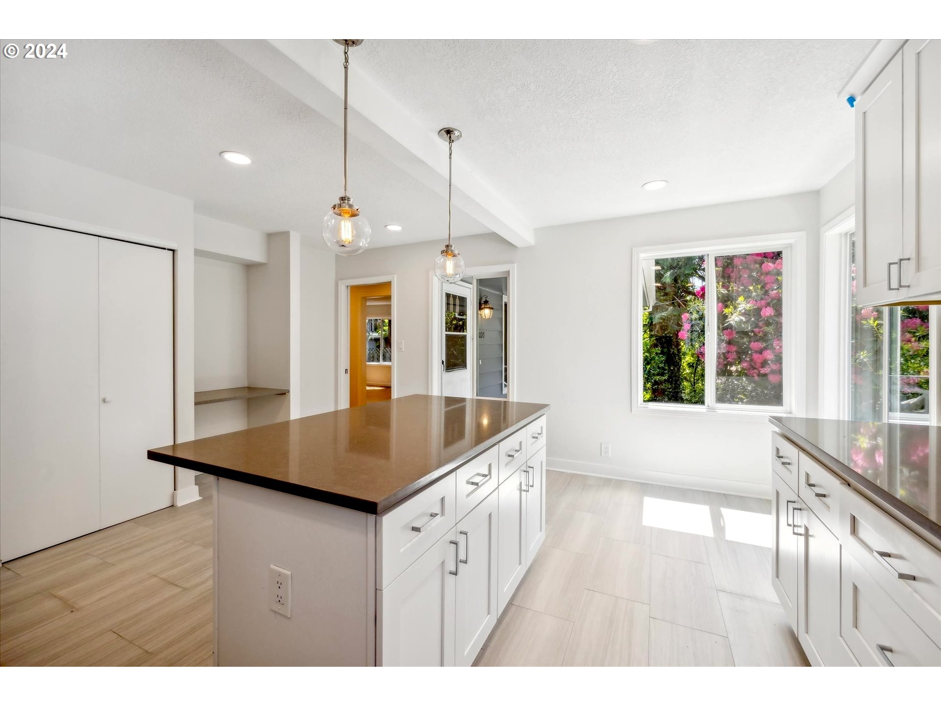 10097 Southwest Walker Road Portland, OR 97225 - Photo 9 of 44 a kitchen with a counter top space and wooden floor
