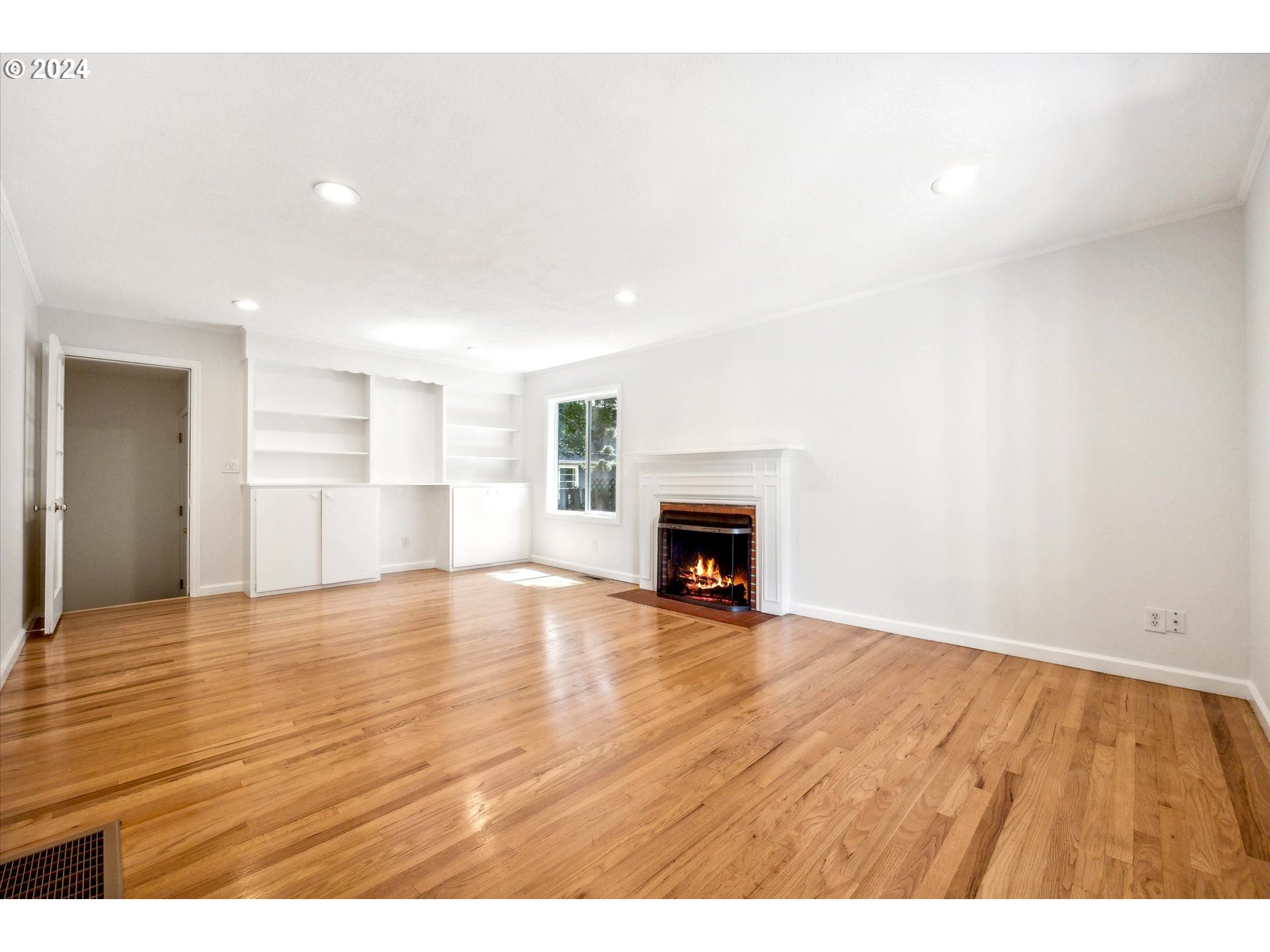 10097 Southwest Walker Road Portland, OR 97225 - Photo 10 of 44 a view of empty room with wooden floor and fireplace