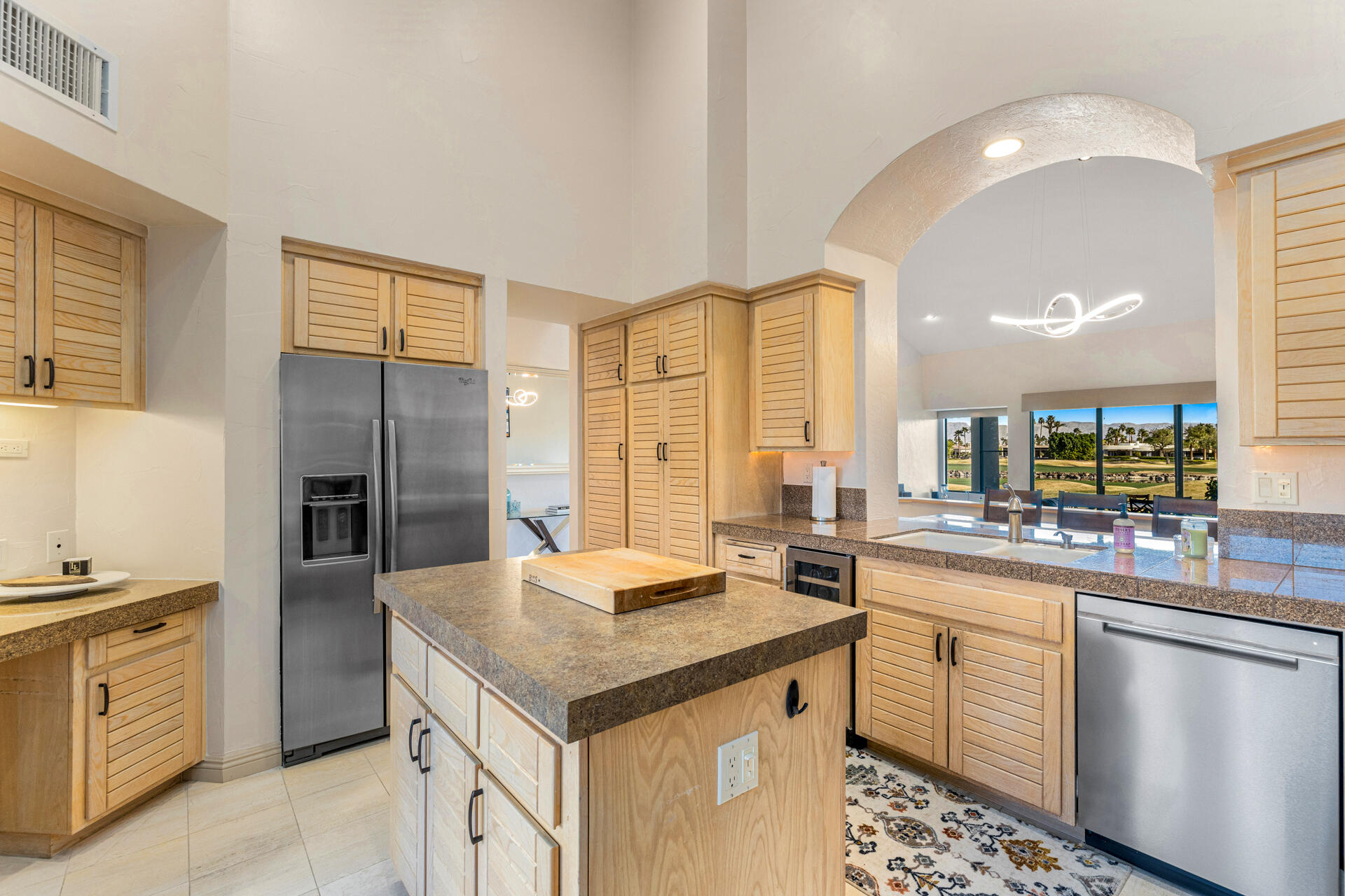 55764 Oak-Tree La Quinta, CA 92253 - Photo 11 of 50 a kitchen with a sink stove and refrigerator