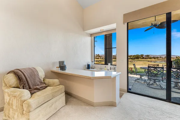 a living room with furniture and a floor to ceiling window