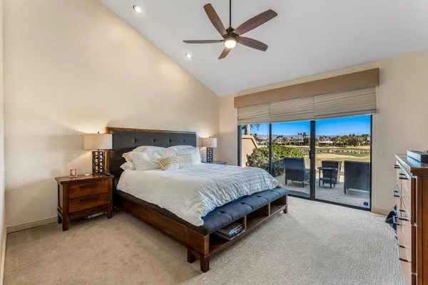 a spacious bedroom with a bed and a walk in closet