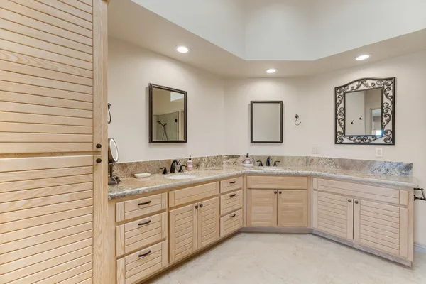 a spacious bathroom with a double vanity sink and a mirror