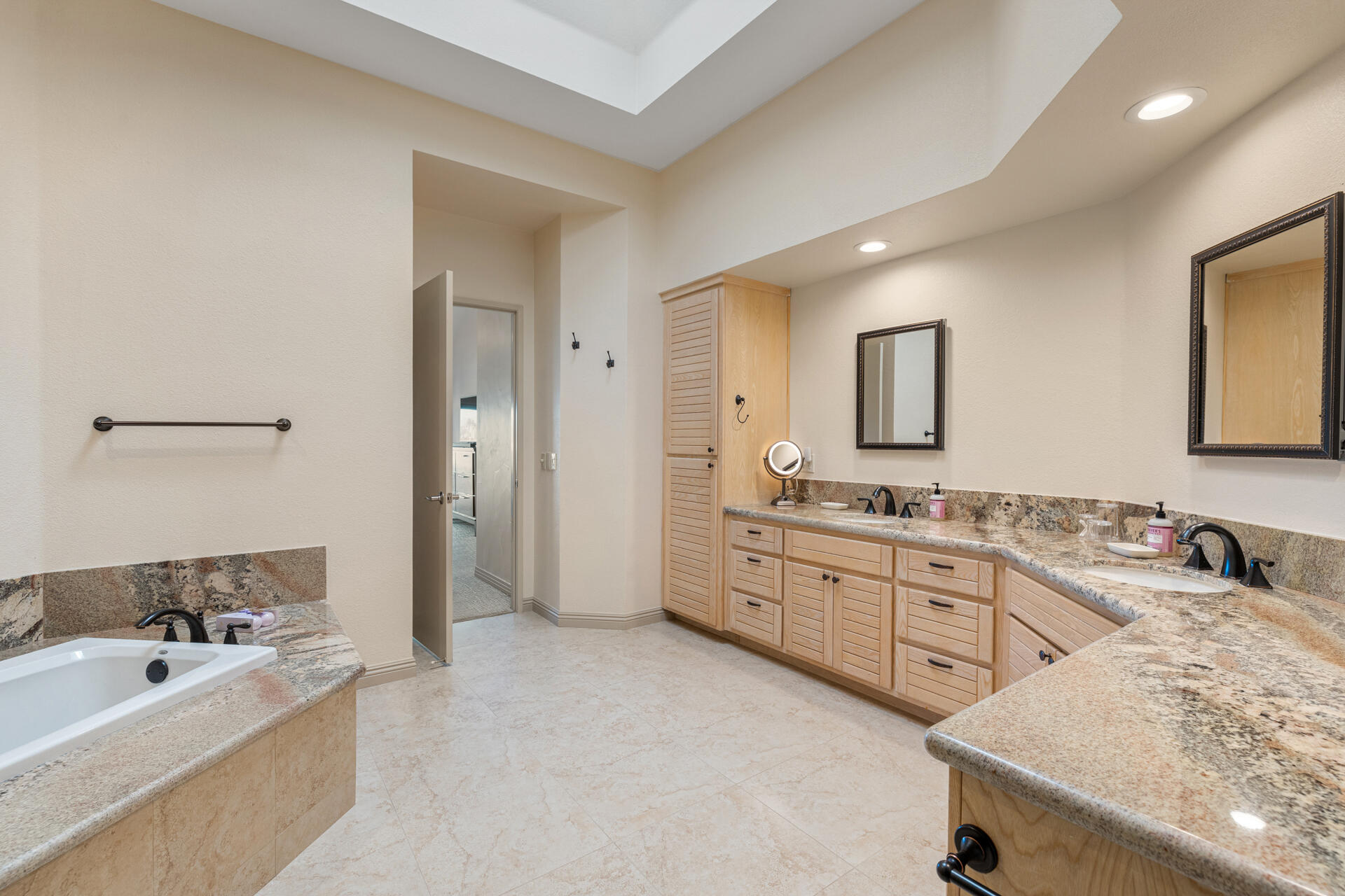 55764 Oak-Tree La Quinta, CA 92253 - Photo 36 of 50 a bathroom with a granite countertop sink mirror and bathtub