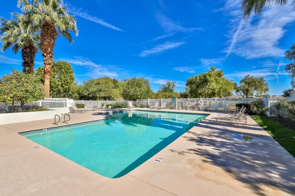 a view of a backyard with swimming pool